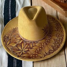 a yellow hat sitting on top of a wooden table