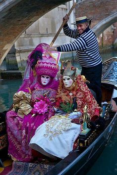 a man and woman dressed up in costume on a gondola