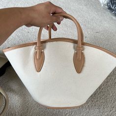 Brand New Never Used. Canvas Fabric With Leather Handles And Pipings. Beige Leather Bucket Bag For Errands, Chic Bucket Bags With Leather Trim, Cream Shoulder Bag With Leather Trim And Top Handle, Chic Bucket Bag With Leather Trim, Brown Canvas Bag With Leather Trim For Errands, Beige Leather Top Handle Canvas Bag, Classic Brown Canvas Shopping Bag, Chic Beige Shoulder Bag With Leather Trim, Beige Canvas Bucket Bag With Top Handle