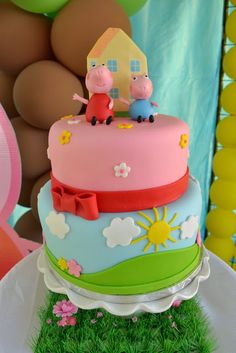 a three tiered cake with pep the pig on top