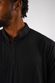 Dress in sartorial sacredness with the sleek and streamlined "Jet" – an all black version of our signature shirt from the Eighteen collection, perfect for any time you need to tee up from the black tees. Inspired by the heritage and legacy of JET magazine, first published in 1951 by John H. Johnson, the name symbolizes "Black and speed," and it'll be sure to help you strike a distinctive silhouette no matter where your journey takes you. Product Details: 4-way Stretch Anti-Odor UPF 30+ Moisture Classic Black Stretch Shirt, Classic Black Shirt With Relaxed Fit, Classic Black Relaxed Fit Shirt, Black Stretch Shirt For Streetwear, Fitted Black Shirt For Streetwear, Classic Black Stretch T-shirt, Black Golf T-shirt, Sporty Moisture-wicking T-shirt For Golf, Black Moisture-wicking Baseball Jersey With Collar