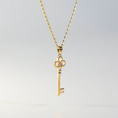 A golden vintage key pendant, oh so bright, with cubic zirconia that shines like light.  This 14K gold Key Pendant is designed to resemble a vintage key, with intricate details and a polished finish. The key's bow is adorned with sparkling cubic zirconia stones that add a touch of glamor to the overall look. Unique and elegant, this handcrafted jewelry will turn heads and leave a lasting impression. Fine jewelry such as this luxury pendant is a staple of fashion accessories and makes a great gif Gold Key Pendant Jewelry, Gold Pendant Jewelry With Keys, Luxury Gold Jewelry With Keys, Yellow Gold Key Pendant Jewelry, Tiffany Key Necklace, Sacred Spiral, Gold Key Necklace, Tiffany Key, Spiral Necklace