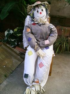 a scarecrow sitting on top of a wooden chair