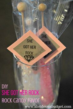 there are some candy sticks in a clear cup with the words she got her rock on it