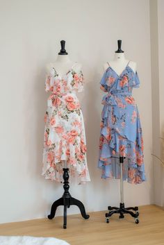 two dresses on mannequins in front of a white wall and wooden floor