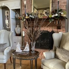 a living room filled with furniture and a fire place in front of a brick wall