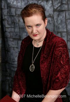 a woman wearing a red jacket and black shirt