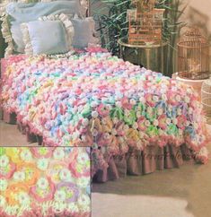 a crocheted bedspread with flowers on it and a birdcage in the background