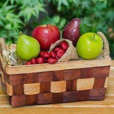 a basket filled with lots of different types of fruit on top of a wooden table