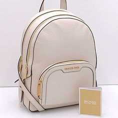 Michael Kors Jaycee Medium Pebbled Leather Backpack Light Cream Pebbled Leather And Gilded Accents Come Together On Our Jaycee Backpacka Timeless Essential That’s Destined To Become Your New Hands-Free Favorite. It Features A Front Zip Pocket For Convenient Access, And Plenty Of Room Inside To Store Your Laptop And Other Necessities. Details Backpack Pebbled Leather 100% Leather Trim: 60% Polyurethane /20% Polyester/20% Cotton Gold-Tone Hardware 8.75”W X 12”H X 4.25”D Exterior Details: Front Zip Light Cream Color, Michael Kors Backpack, Bags Michael Kors, Light Backpack, Exterior Details, Medium Backpack, Light Cream, Cream And Gold, Beauty Bag