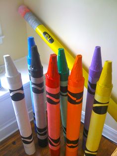 several crayons are lined up on the floor