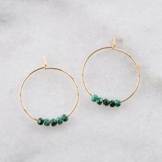 Delicate hoops — choose gold or silver, economical plated or luxe gold filled — with chunky malachite beads. Equally earthy and ethereal, perfect for every day. 25mm (about 1") gold-plated hoops with 2x3mm Malachite beads 25mm (about 1") gold-filled hoops with 2x3mm Malachite beads 25mm (about 1") silver-plated hoops with 2x3mm Malachite beads packaged on a hand-stamped kraft earring card in a clear resealing bag Not sure which gemstone to choose? This blog post might help: Get Your Woo-Woo on w Small Hoop Emerald Jewelry For Gifts, Emerald Hoop Earrings Gift, Everyday Nickel-free Jewelry With Round Beads, Everyday Wire Wrapped Round Bead Jewelry, Gold Hoop Earrings With Natural Stones, Small Emerald Hoop Earrings As A Gift, Dainty Hoop Earrings With May Birthstone, Dainty May Birthstone Hoop Jewelry, Round Gemstone Beads Hoop Earrings As Gift