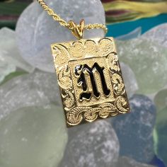 Feel the aloha with this personalized pendant! Our custom-engraved Hawaiian Scroll Heirloom Initial Pendant is available in 14k gold plated sterling silver or sterling silver. Add a special message to the back for just $15 and guarantee it's one-of-a-kind! Each pendant comes with a 20" gold-filled rope chain, making it perfect for both men and women. Mahalo! 14K Gold Plating over .925 Sterling Silver or Sterling Silver Choose Initial in Black Enamel or Raised Lettering Pendant is approx. 1" Tall Symbolic 14k Gold Jewelry With Engraving Option, Spiritual 14k Gold Initial Pendant Jewelry, Spiritual Engraved Jewelry For Personalized Gift, Symbolic Yellow Gold Jewelry With Engraving Option, Custom Gold Nameplate Jewelry, Custom 14k Gold Initials Necklace For Gift, Engraved Custom Nameplate Necklace For Anniversary, Sterling Silver Nameplate Jewelry With Initials, Personalized Yellow Gold Square Pendant Jewelry