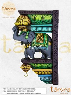 an elephant figurine sitting on top of a shelf with ornate designs around it