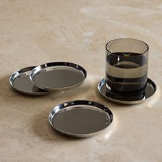 Condensation has nothing on these polished stainless-steel coasters. Each one has a shallow lip to contain drips, while a generous diameter saves room for stemmed glasses, wine bottles, and beyond. Set of 4 coaster. Top-rack dishwasher safe. Polished stainless steel. Shallow lip to contain drips. Anti-slip back. Generous diameter. Heavyweight feel. Stackable, low-profile design. Holcomb Stainless Steel Puddle Coasters, Set of 4 Tampa Apartments, Silver Coasters, Cooking Contest, Cool Coasters, Apt Ideas, Save Room, When I Die, Glass Coasters, Dishwasher Racks