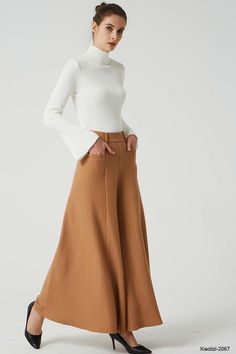 "This fashion brown wide leg pants is designer from XIAOLIZI. The long wool pants made high waisted + back zipper closure + front two up entry pockets + many front pleated add to the wide leg cut of our maxi pant, makes the warm pants more fashionable and warm in winter, it's elegant and classic womens pants, come on! Your wardrobe should have it. DETAIL * Made from Wool fabric, polyester lining * back zipper closure * two up entry pockets * winter pant, warm pant, long pants, maxi pants CUSTOM Beige Wide Leg Wool Pants, Fitted Wool Wide Leg Pants For Fall, Wide Leg Beige Wool Pants, High-waisted Wool Pants For Fall, Fall High-waisted Wool Pants, Modern Wide Leg Wool Pants, Beige Wool Wide Leg Pants, Chic Wool Bottoms For Fall, Chic Beige Wool Pants