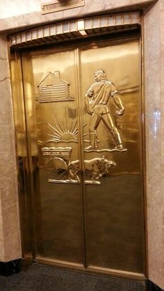 the door to an elevator is decorated with gold