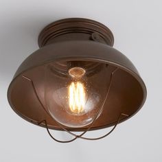 a light that is on the side of a wall mounted ceiling fixture in an old - fashioned style