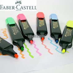 four different colored ink pens sitting next to each other on top of a white paper