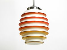 an orange and white light hanging from a ceiling