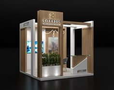 a small booth with a plant in the center and lights on it's sides