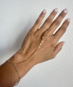 Hand Chain Ring Bracelet, CZ Stone, Rolo Link Chain, Bridal Dainty Bracelet, Finger Link Ring Chain, Mothers day 2024 gift Description: * Material: 18K Gold Filled * Quantity: Finished Bracelet * Length: Bracelet Size (6 3/4' Inch) + 2" EXT * Length (Wrist to finger): 4' Inch * Thickness: 2mm * Color: Gold **HOW TO CARE FOR YOUR JEWELRY *Maintain your jewelry's high shine by avoiding contact with any chemicals such as soap, perfume, lotion, makeup, hair & cleaning products. *When you do not use the jewelry you bought, you can always keep it in a pouch or box, reducing its contact with oxygen and wearing it for many years with its first day's shine. *You can do your product maintenance with a cotton-soft dry cloth. *You can always be stylish with the products you keep in the boxes sent to y Gold Resizable Jewelry For Party, Adjustable Chain Dangle Bracelet For Gift, Delicate Adjustable Gold Body Jewelry, Adjustable Chain Bracelet For Gifts, Adjustable Delicate Chain Body Jewelry For Wedding, Delicate Adjustable Bracelet Jewelry, Adjustable Delicate Bracelet Jewelry, Adjustable Dainty Chain Bracelet For Parties, Adjustable Metal Jewelry For Promise