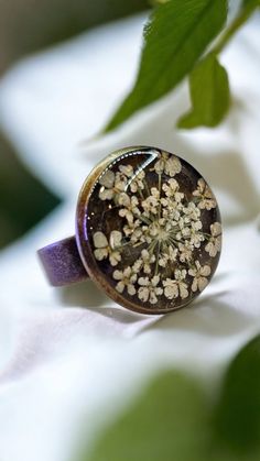 Welcoming a little piece of nature for someone unerring! Enjoy this pressed Queen Anne's Lace Ring pressed before encapsulating them with resin. Ring Measures, Tray: 16mm, 5x17mm Pendant Measures: Oval Tray: 25x18mm, 42.5x23.5x2mm, Hole: 3mm The Antique Bronze ring is adjustable and comes in a beautifulgift box.. All Jewelry findings are Lead and Nickel free. The petals have been carefully preserved to retain their color and would make a great gift for your loved ones. This piece was made with r Handmade Brown Flower Jewelry, Bohemian Jewelry As A Gift Featuring Birth Flower, Antique Handmade Rings As Gifts, Antique Handmade Rings Perfect As Gifts, Antique Handmade Rings For Gift, Bohemian Brown Flower Jewelry, Adjustable Copper Flower Jewelry, Vintage Jewelry With Natural Inclusions For Weddings, Brown Flower-shaped Jewelry Gift