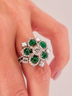 Elegance in Bloom: The Handmade Platinum Entourage Diamond and Cabochon Cut Green Emerald Ring Behold the exquisite charm of this handmade platinum ring, a captivating blend of diamonds and cabochon-cut green emeralds, all woven into a delightful flower and snowflake motif.**Nature's Inspiration**The ring captures the essence of nature's beauty. In its design, you'll find the delicate and harmonious balance of a flower and a snowflake, both elements of nature that have fascinated and inspired artists and admirers for centuries.**Luminous Cabochon Cut Green Emeralds**At the heart of this exquisite creation are five cabochon-cut green emeralds, set to mimic the radiant allure of flower petals. Each emerald, with its alluringly deep green hue, is a testament to the captivating beauty of natur Green Emerald Ring, Elements Of Nature, Chains Necklaces, Platinum Ring, Shop Engagement Rings, Green Emerald, Custom Engagement Ring, Emerald Ring, Chain Ring