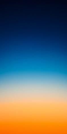 an airplane is flying in the sky at sunset or sunrise with orange and blue hues