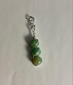 ✧NEW STORE SALE - GRAND OPENING✧ ♡ Find all of my Handmade jewelry and unique pieces wrapped by me discounted for this short time ♡ I personally make each piece in-house. Each piece of jewelry is wrapped with care and good vibes.  Everything is one of a kind. No rock, stone, or gem is the same! Various materials are available. THIS ITEM IS: Green Jade Beaded Necklace, USA Hand Made Silver wire wrapped pendant. Triple beaded design with spiraling silver wire wraps around for a striking design. Hangs Middle/Low on chest. Results may vary depending on your size. Each jade bead will be unique and different than the others creating a One of A Kind look to this necklace.  ✧Gem/Stone dimensions✧ Shown in photos. Beads stack up to around 1IN and the entire pendant is a bit longer than that. Great Green Wire Wrapped Beaded Necklaces With Round Beads, Dangling Pendant Beads For Jewelry Making, Wire Wrapped Round Beads For Jewelry Making, Green Round Beaded Nickel-free Necklace, Green Spiritual Jewelry With Dangling Beads, Spiritual Green Jewelry With Dangling Beads, Green Nickel-free Round Beaded Necklace, Jade Bead Necklace, Sale Store