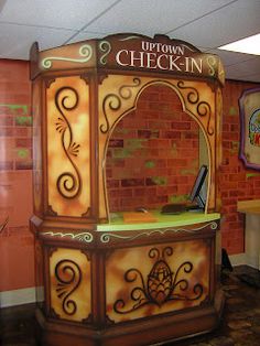 an old fashioned checkin counter in front of a brick wall