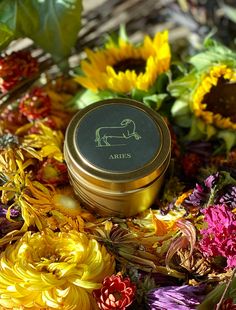 a tin with the word aris on it surrounded by sunflowers and other flowers