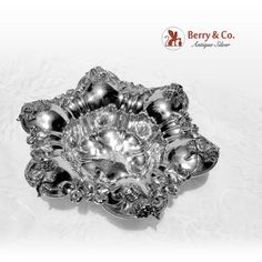 an ornate silver dish on a white background