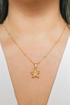 Introducing our Patricia Starfish Necklace, a charming piece inspired by coastal beauty. This necklace showcases a delicate starfish pendant, adding a subtle touch of seaside charm to your look. Versatile and understated, it's a lovely accessory for everyday wear, bringing a hint of coastal style to any outfit. All of our jewelry comes with a free jewelry pouch and cloth to keep your pretties safe and clean. Details Color: 18K Gold PlatedMaterial: Stainless SteelSize: 16in + 5cm extender Care Gu Dainty Starfish Necklace For Beach, Ocean-inspired Necklaces With Star Charm, Ocean-inspired Jewelry With Star Charm, Yellow Gold Starfish Jewelry In Ocean-inspired Style, Yellow Gold Starfish Ocean-inspired Jewelry, Ocean-inspired Starfish Yellow Gold Jewelry, Elegant Starfish Charm Necklace For Beach, Yellow Gold Starfish Charm Necklace For Beach, Yellow Gold Necklace With Starfish Charm For Beach