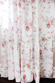 the curtains are covered with floral fabric