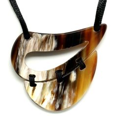 Lightweight, durable and beautifully handcrafted jewelry made out of buffalo horn. Inspired in Puerto Rico and handmade in Vietnam. A beautiful pendant with strap, handmade from buffalo horn, lightweight and high polished finish. All necklaces are hand made out of natural material, colors will vary. 3.35" Length x 2.56" Wide --TAB-- Joyas livianas, duraderas y delicadamente hechas a mano de cuerno de búfalo. Inspirado en Puerto Rico y hecho a mano en Vietnam. Un hermoso colgante con tira, hecho Cow Horns, Horn Jewelry, Horn Pendant, Wood Jewellery, Artistic Jewelry, Puerto Rico, Handcrafted Jewelry, Semiprecious Stones, Precious Stones