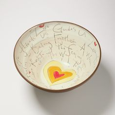 a bowl with writing on it and a heart