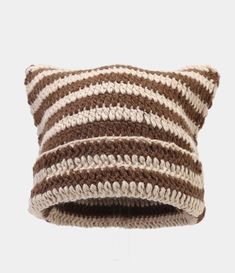 a brown and white striped knitted pillow