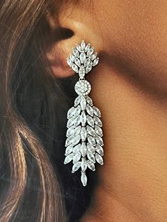 The SADIE statement earrings feature an exotic and unique look that can be worn for any occasion. The design gives it a 3D look to make the earrings refined and enduring. These will surely be the go to earrings in your high style collection and big event! Handcrafted Highest Quality Swarovski / Cubic Zirconia Platinum plated Guards against scratches and tarnish. approximate size 2.5" length 1" width Nickel free Free Shipping in USA Glamorous Long Drop Cubic Zirconia Chandelier Earrings, Luxury Cubic Zirconia Statement Earrings, Luxury Sterling Silver Bridal Earrings, Exquisite Style, Glamorous Crystal-embellished Dangle Bridal Earrings, Wedding Reception Gowns, Evening Bridal Earrings, Cubic Zirconia Dangle, Reception Gown, Boutique Couture, Pretty Legs