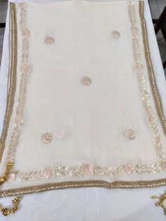 Item Overview ATHARVA Hand Embroidered/Indian Wedding Dupatta/Cream Off White Chiffon/Gota Work & Pink Thread Work/Tassels/Stole/Wrap/Sarong/Chunni/DUP24 ⚘Dno. DUP24 ⚘Hand Embroidered Gota Patti Dupatta/ Stole/ Scarf/Soft Chiffon Chinnon Dupatta ⚘Fabric Customisation: Options Available A. Net B. Organza C. Chiffon Chinnon D. Georgette E. Tabby Silk F. Pure Chiffon (Chamandi) ⚘Length: 2.5 Mtrs ⚘Width: 1.12 Mtrs ⚘Excusive Hand Embroidered Gota Patti Work ⚘Customization: * Fabrics: Designs Can be m Bollywood Style Off White Dupatta With Gota Work, Off White Dupatta With Gota Work For Festivals, Festive Off White Sheer Dupatta, Cream Festive Shawl, Bohemian White Sharara For Wedding, White Silk Traditional Wear With Embroidered Border, Traditional Cream Saree With Dupatta, Cream Saree With Dupatta In Traditional Drape, Cream Georgette Traditional Wear With Sheer Dupatta