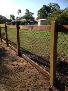 an image of a fence that is in the middle of some dirt and grass area