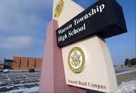 there is a sign for the marine township high school in front of snow covered ground