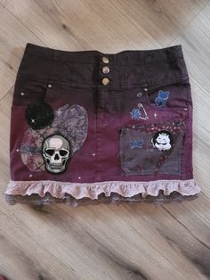 This skirt was thrifted from Valley Village. I first dyed the top black then sewed on patches of fabric and a skull patch. Lastly I added ribbon at the bottom and painted a couple of designs with fabric paint! I don't know what brand the skirt is from, their tag was cut off. Grunge Cotton Mini Skirt, Patched Skirt, Skirt With Patches, Patch Skirt, Patch Pants, Skull Patch, Valley Village, Purple Jeans, Black And Purple