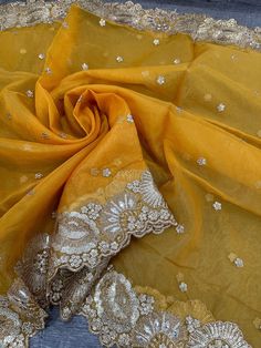 Organza dupatta with gold embroidered border. Embroidered Sheer Dupatta For Festive Occasions, Chikankari Embroidery Dupatta In Tissue Silk, Yellow Embroidered Unstitched Anarkali Set, Sheer Dupatta For Diwali, Elegant Dola Silk Anarkali Set With Embroidered Border, Elegant Gold Salwar Kameez With Embroidered Border, Festive Yellow Anarkali Set With Embroidered Border, Gold Tissue Silk Anarkali Set With Sheer Dupatta, Gold Anarkali Set With Sheer Dupatta In Tissue Silk