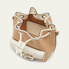 Valentino Garavani "Loco" bucket bag in polyester, metal, and raffia  Detachable flat top handle  Detachable, adjustable web shoulder strap Can be worn as a top handle or shoulder bag  Drawstring closure  Exterior, VLOGO front flap pouch  Lining: Cotton Approx. 7.5"H x 6.3"W x 4.3"D Made in Italy Designer Beige Bucket Shoulder Bag, Designer Top Handle Bucket Bag For Errands, Designer Bucket Bag For Errands, Luxury Canvas Satchel Bucket Bag, Canvas Bucket Bag With Adjustable Top Handle, Designer Beige Bucket Bag, Designer Bucket Hobo Bag With Removable Pouch, Designer Bucket Bag With Detachable Strap For Errands, Designer Beige Bucket Shape Shoulder Bag