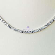 Elegant, with amazing fire and brilliance is the only way to describe this gorgeous necklace. Wear it to a special occasion or work, it is sure to capture everyone's attention. Pair this necklace together with my 3mm Moissanite tennis bracelet, and my 3mm Moissanite wedding band for a beautiful set. CERTIFICATION: Along with your necklace you will receive a GRA certificate of authenticity and warranty card. RESIZING: Each setting cannot be separated, therefore I will not be able to resize the ne Silver Moissanite Tennis Necklace, Sterling Silver Round Cut Tennis Necklace For Gift, Sterling Silver Tennis Necklace Gift, Gift Sterling Silver Tennis Necklace, Gift White Gold Tennis Necklace With Vvs Clarity, Silver Tennis Necklace With Vvs Clarity As Gift, White Gold Cubic Zirconia Tennis Necklace Gift, Silver Diamond Cut Tennis Necklace Gift, Silver Round Cut Tennis Necklace For Anniversary