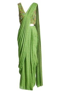 This saree has a hand-embroidered cropped top with intricate beadwork and lustrous sequins and is paired with a skirt featuring attached wraparound draping. This outfit is prestitched, so you can put it together in 30 seconds or less. V-neck Top has hook-and-eye closure; skirt has hidden side-zip closure Top and skirt feature hook-and-eye attachments for easy drape adjustments Lined 100% viscose Spot clean Made in India Asian & Pacific Islander Owned/Founded Embroidered Draped Traditional Wear For Diwali, Traditional Draped Sequin Dress, Festive Embroidered Draped Blouse Piece, Traditional Draped Sharara With Mirror Work, Traditional Embroidered Draped Blouse Piece, Traditional Embroidered Draped Dupatta, Designer Embroidered Draped Saree, Draped Georgette Traditional Wear With Mirror Work, Draped Choli With Zari Work For Festivals