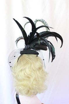 Black Feather Fascinator with Dotted Veil, Showgirl Peacock Headpiece, High Fashion Hat, Ascot Races, Kentucky Derby, Halloween Wedding This hat is huge and fantastic. It is made from a sturdy hand blocked buckram base (I use two layers of buckram) that has been wired and then covered in felt and then covered in a black brushed satin. A spray of huge black iridescent coquille feathers and perfectly curled peacock swords set on top of this perfectly you can wear it on either side of your head for Fitted Black Feathered Headpiece, Fitted Black Headpiece With Feathers, Black Feathered Headpiece, Adjustable Fascinator For Costume Carnival, Adjustable Fascinator For Carnival Costume, Black Feathered Wedding Costume Hat, Black Feathered Costume Hat For Wedding, Fitted Black Headband For Costume Party, Fitted Fascinator For Costume Occasions