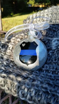 an ornament with a thin blue line on it sitting on top of a blanket