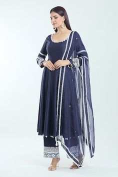 Navy blue chanderi anarkali with contrasting embroidery detailing on the neckline and sleeves. Comes with an intricate embroidered pant and embroidered organza dupatta. - Aza Fashions Long Sleeve Anarkali Set With Embroidered Border For Navratri, Blue Anarkali Set With Embroidered Border, Festive Blue Dress With Embroidered Border, Anarkali Cotton Silk Traditional Wear With Embroidered Border, Anarkali Traditional Wear With Embroidered Border, Fitted Blue Anarkali Set With Embroidered Border, Designer Blue Dresses With Embroidered Border, Blue Cotton Silk Salwar Kameez With Embroidered Border, Blue Chanderi Anarkali Set With Embroidered Border